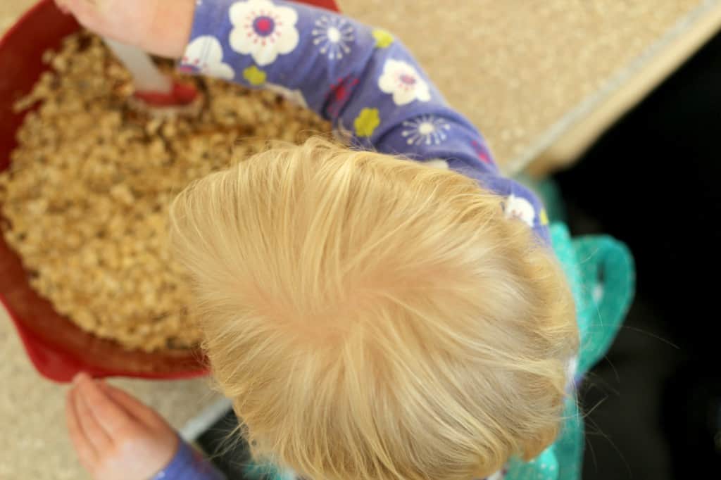 image of child stirring bowl of granola bar mixture
