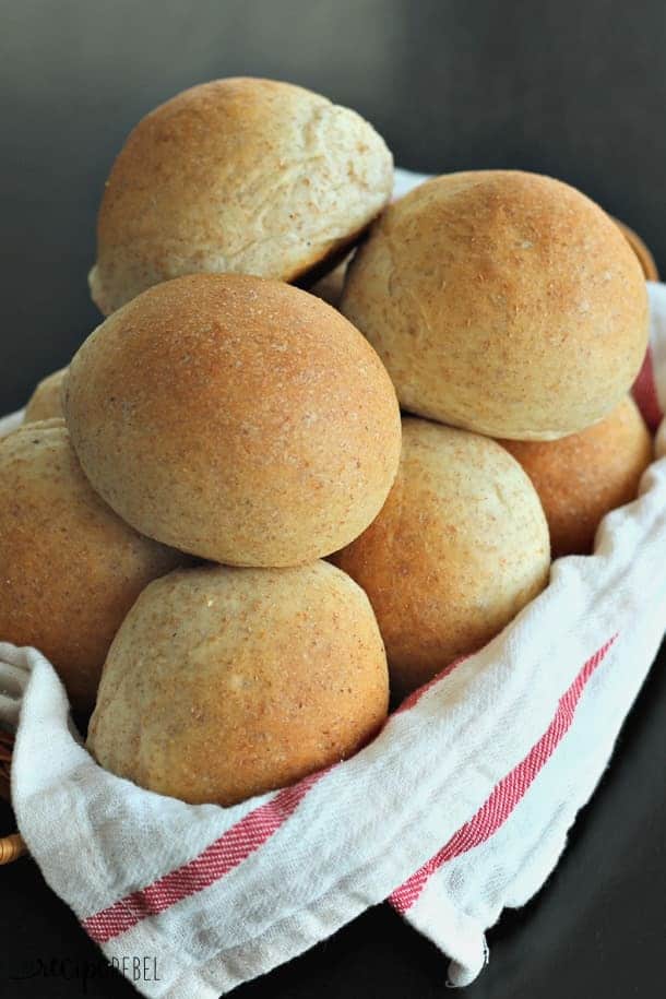 whole wheat bread machine rolls in basket with white towel