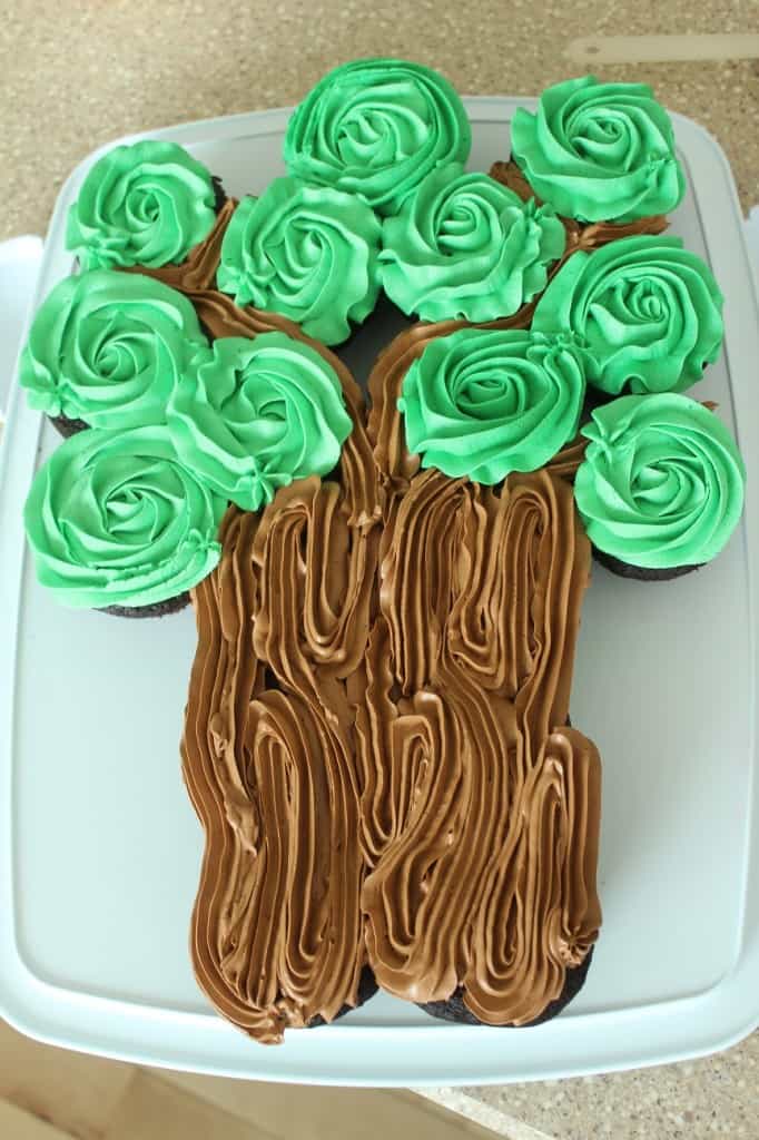 green frosting on chocolate cupcakes showing tree leaves