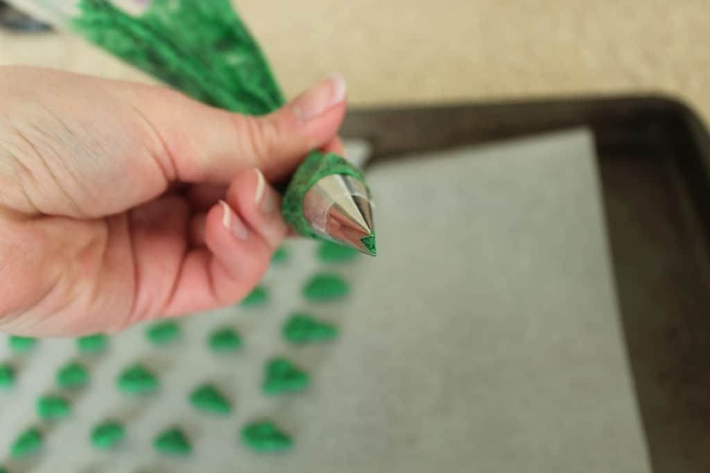 green frosting in piping bag with leaf tip