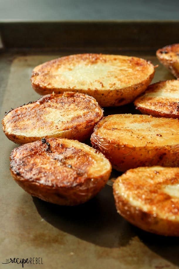 close up image of red potatoes on sheet pan with crispy tops