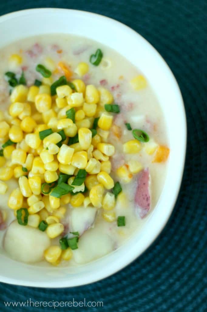 close up overhead image of sausage potato chowder with corn and green onions on top