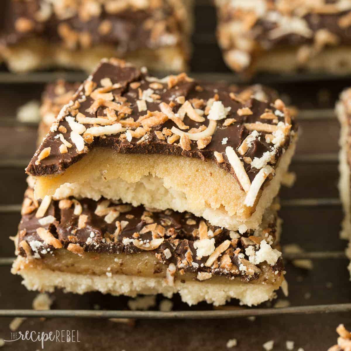 stack of two samoa shortbread bars with bite taken out of top bar