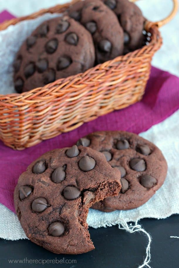 two chocolate pudding cookies stacked and a bite taken out of one cookie