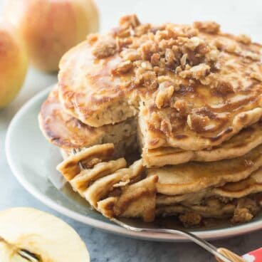 These Apple Crisp Pancakes are soft, fluffy cinnamon pancakes filled with shredded apple and topped with brown sugar crumble -- a decadent weekend breakfast!