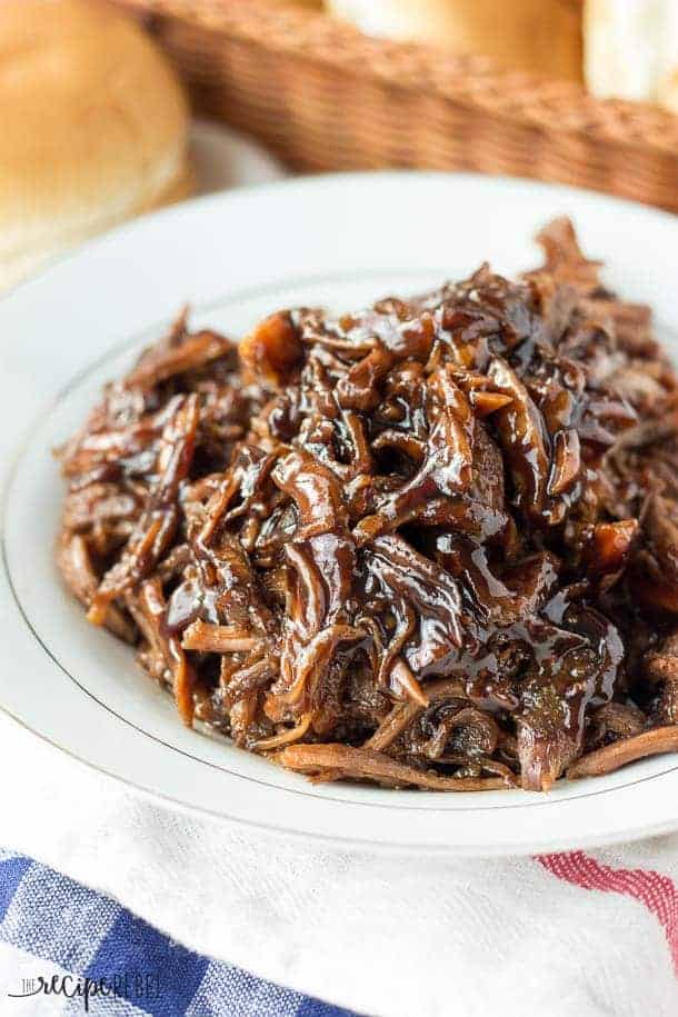 close up image of pulled pork with honey balsamic sauce in white plate