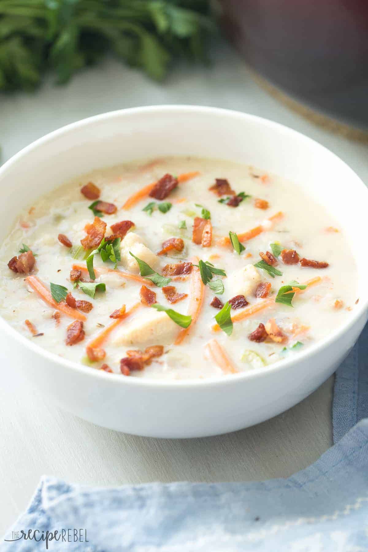 quick creamy chicken bacon rice soup in white bowl with parsley on top