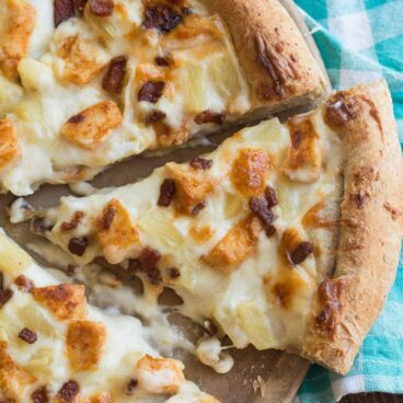 Boston Pizza copycat Tropical Chicken Pizza has alfredo sauce, spicy chicken, bacon and pineapple! A crazy but insanely good combination!