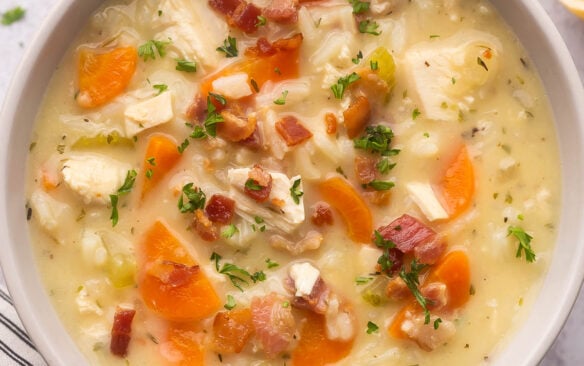 square image of a bowl of chicken rice soup with bacon.