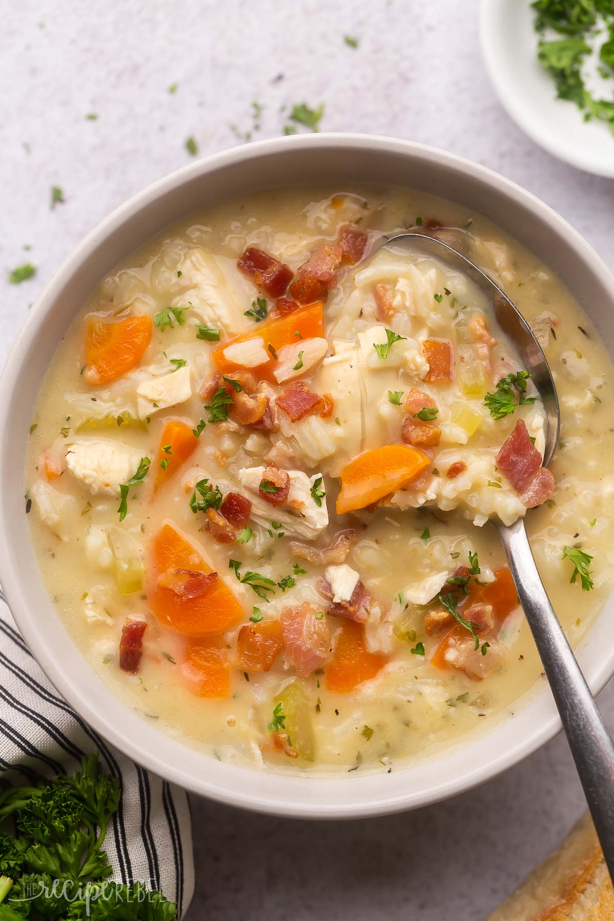 overhead image of chicken rice soup in a bowl with a spoon.