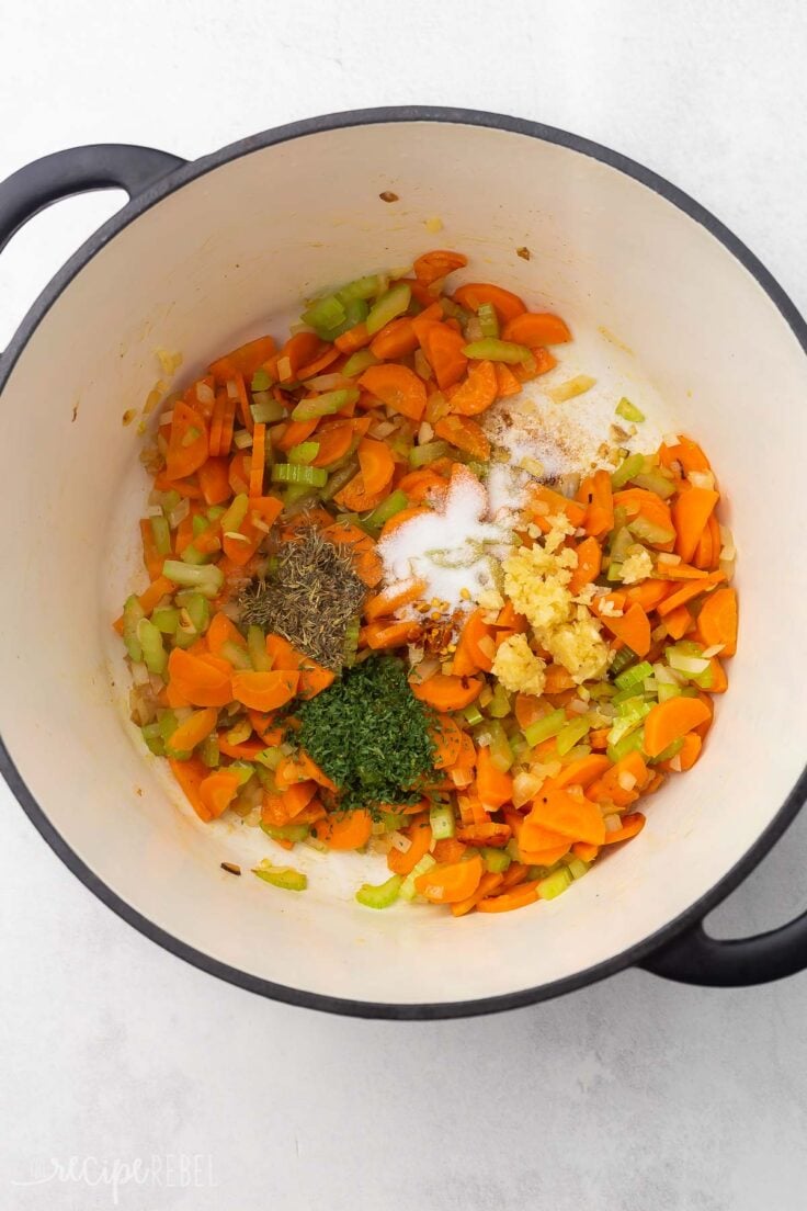 spices and garlic added to soup pot.