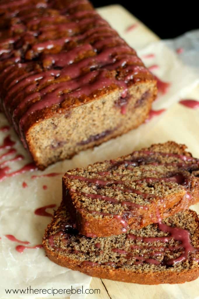 pb & j banana bread with two slices cut drizzled with pink glaze