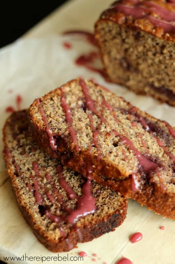 two slices of peanut butter and jelly banana bread up close with pink glaze
