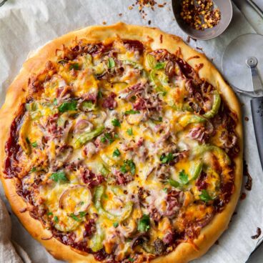 overhead image of full philly cheesteak pizza