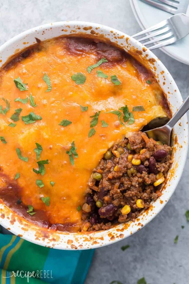 bbq chili shepherd's pie overhead in white casserole dish with cheddar cheese on top