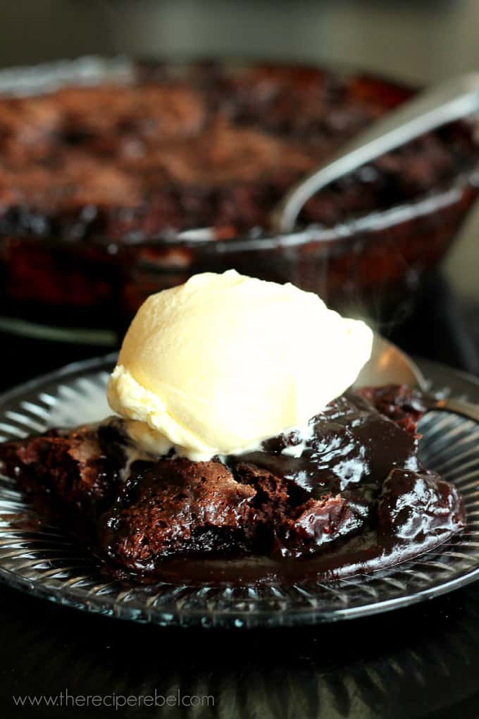 glass plate with hot fudge sundae cake and a scoop of ice cream
