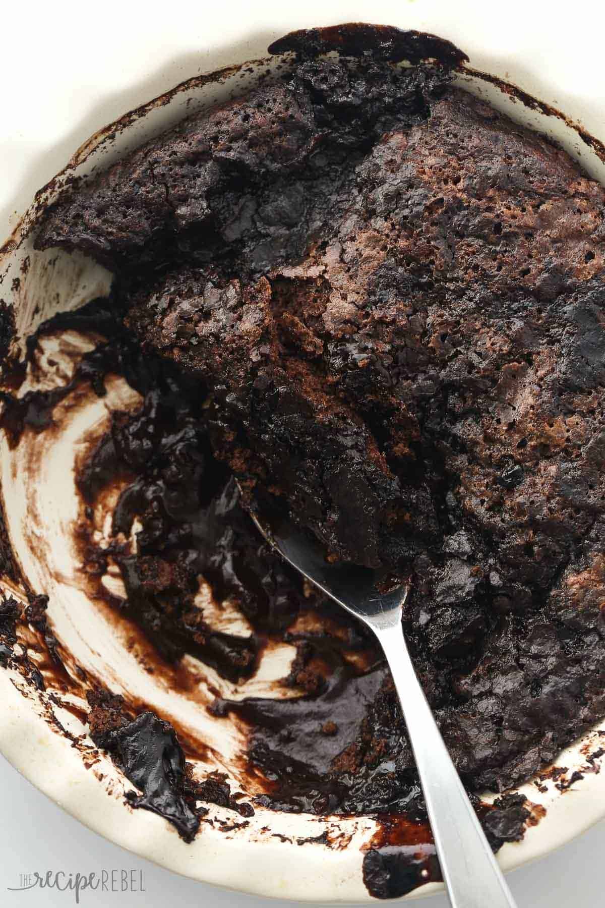 overhead image of white pie plate with metal spoon scooping cake