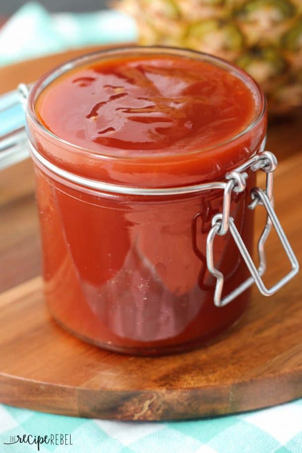 Pineapple Brown Sugar Barbecue Sauce: so easy! The perfect sweet and tangy barbecue sauce that's great on chicken, pork, or beef. www.thereciperebel.com glass jar with pineapple brown sugar bbq sauce with whole pineapple in the background