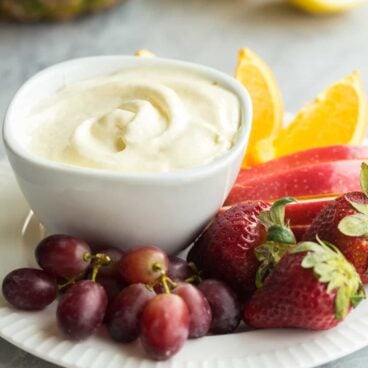 This creamy Pineapple Lemonade fruit dip is made with a homemade pineapple lemon curd and whipped cream! Change up the fruit juice flavors to make any kind!