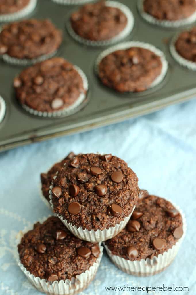 double chocolate banana bran muffins stacked on blue towel