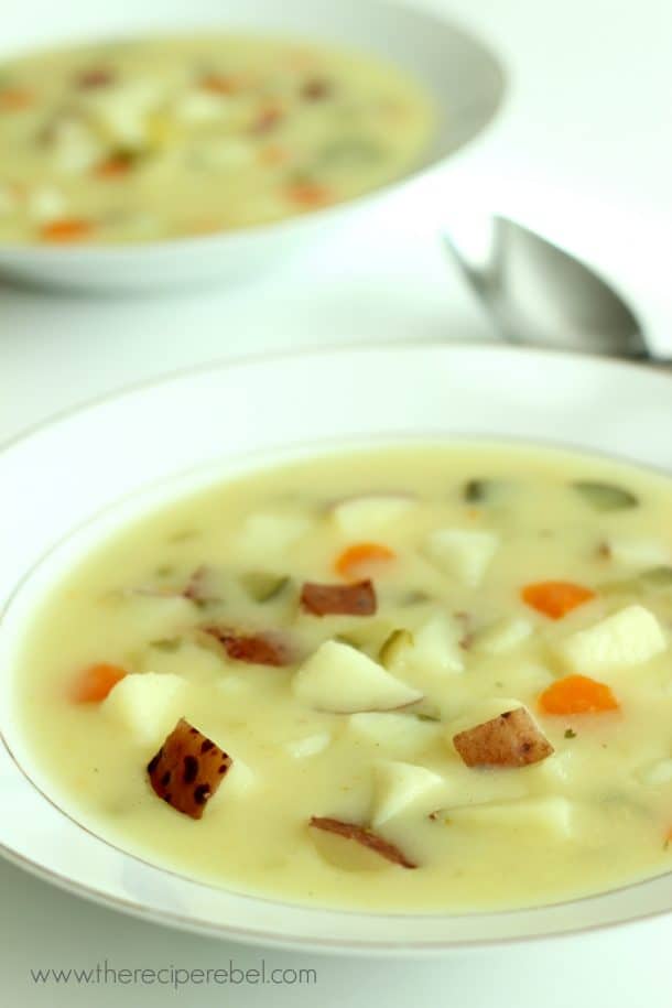 close up of dill pickle soup in white bowl