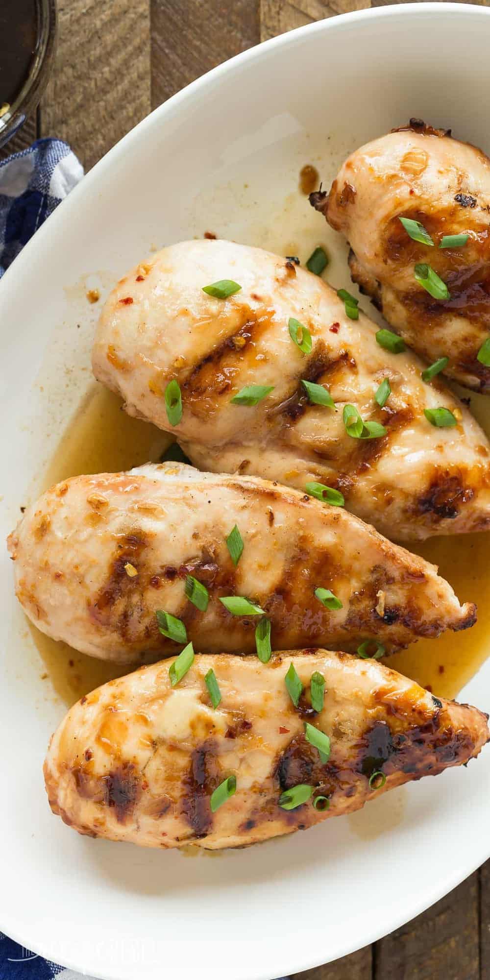 overhead image of coconut grilled chicken breasts with green onion slices