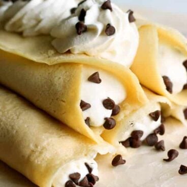 Cannoli Crepes: Soft homemade crepes filled with sweet ricotta cream and chocolate chips, topped with whipped cream and more chocolate chips. A breakfast version of an Italian favorite! www.thereciperebel.com