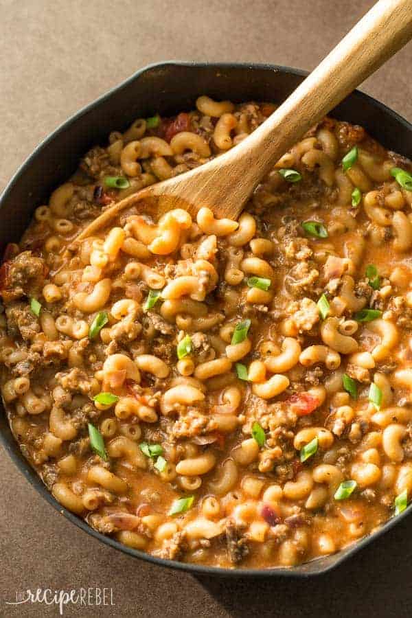 hamburger helper overhead in one black skillet with wooden spoon