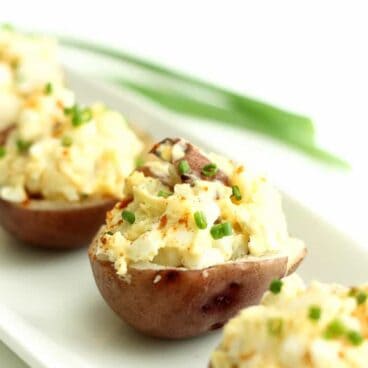 Potato Salad Bites: creamy potato salad stuffed into a tender potato shell. Easy to make ahead and serve at your next barbecue or party! www.thereciperebel.com