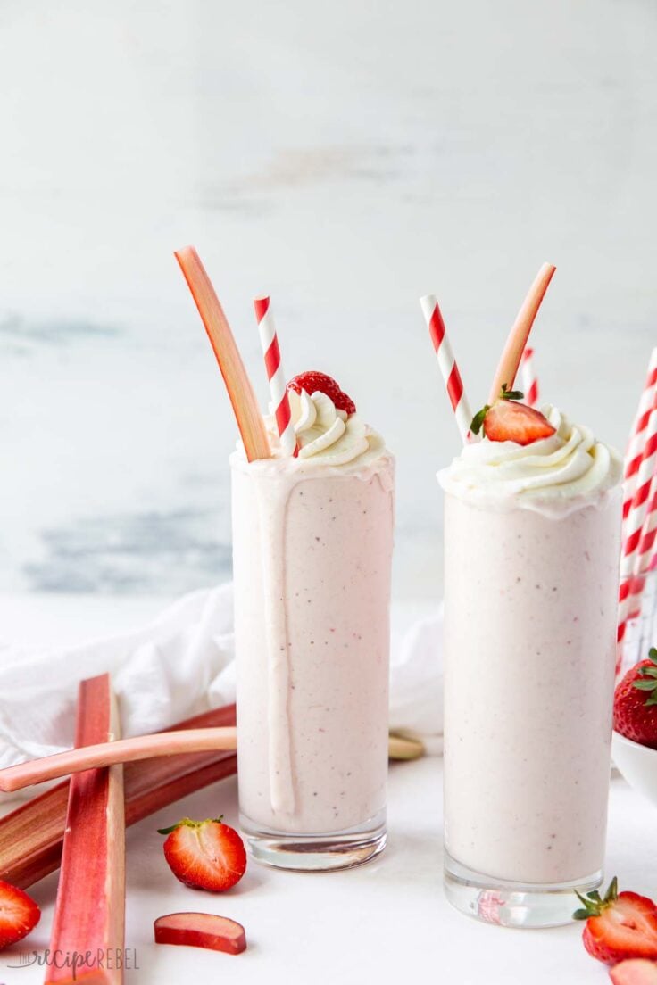 strawberry rhubarb milkshakes with fresh strawberries and rhubarb on the side