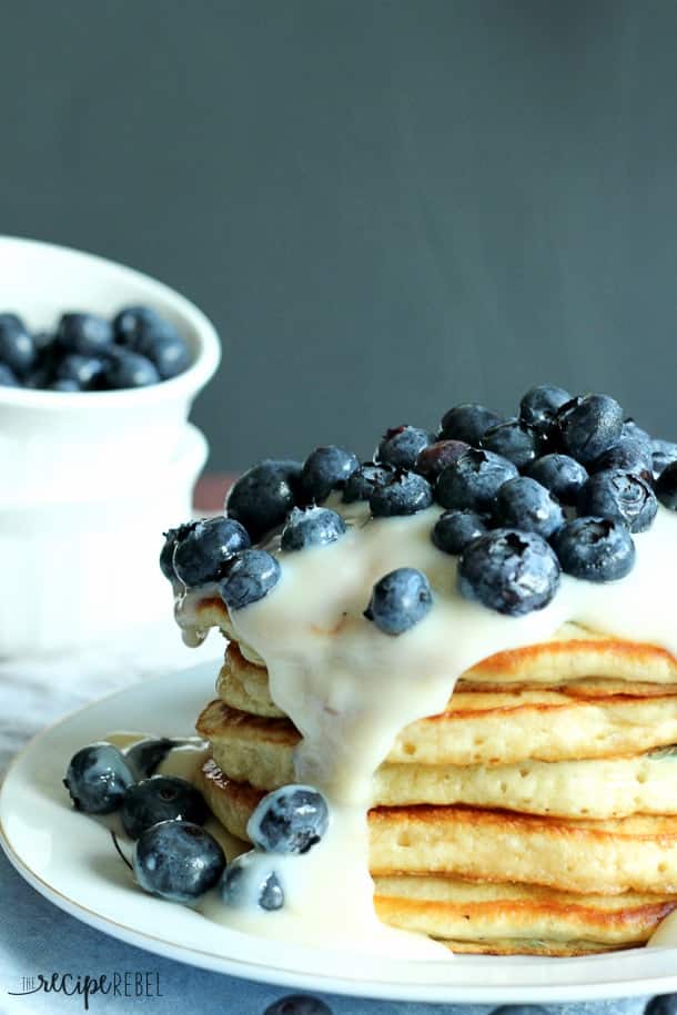 close up image of tall stack of blueberries and cream pancakes