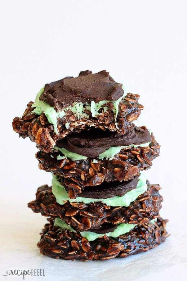 stack of four mint chocolate no bake cookies with a bite taken out of the top cookie