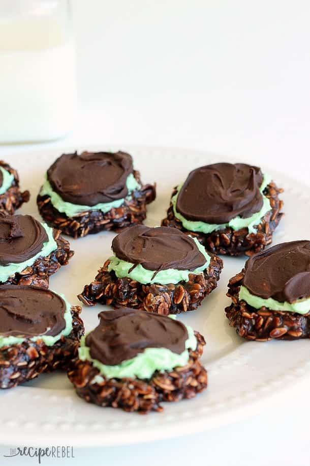white plate full of no bake chocolate cookies with mint frosting and chocolate ganache