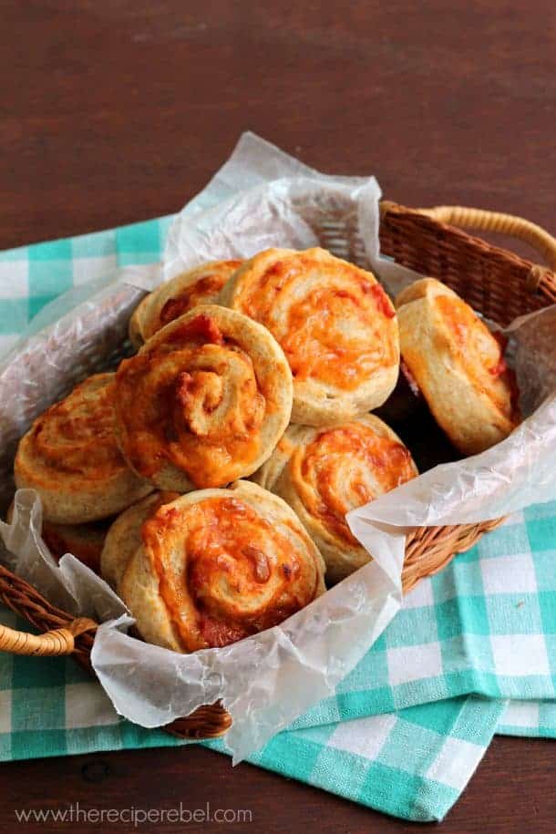 basket lined with parchment paper filled with pizza buns