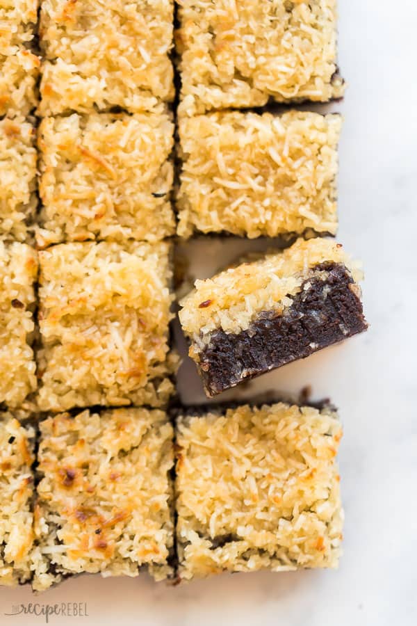 These Lazy Daisy Brownies are ultra fudgy and topped with a broiled coconut frosting similar to Lazy Daisy Cake. They are the brownies for toasted coconut lovers! #brownie #chocolate #baking #dessert lazy daisy brownies sliced overhead with one brownie sitting on its side