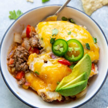 close up image of mexican shepherds pie in bowl with spoon