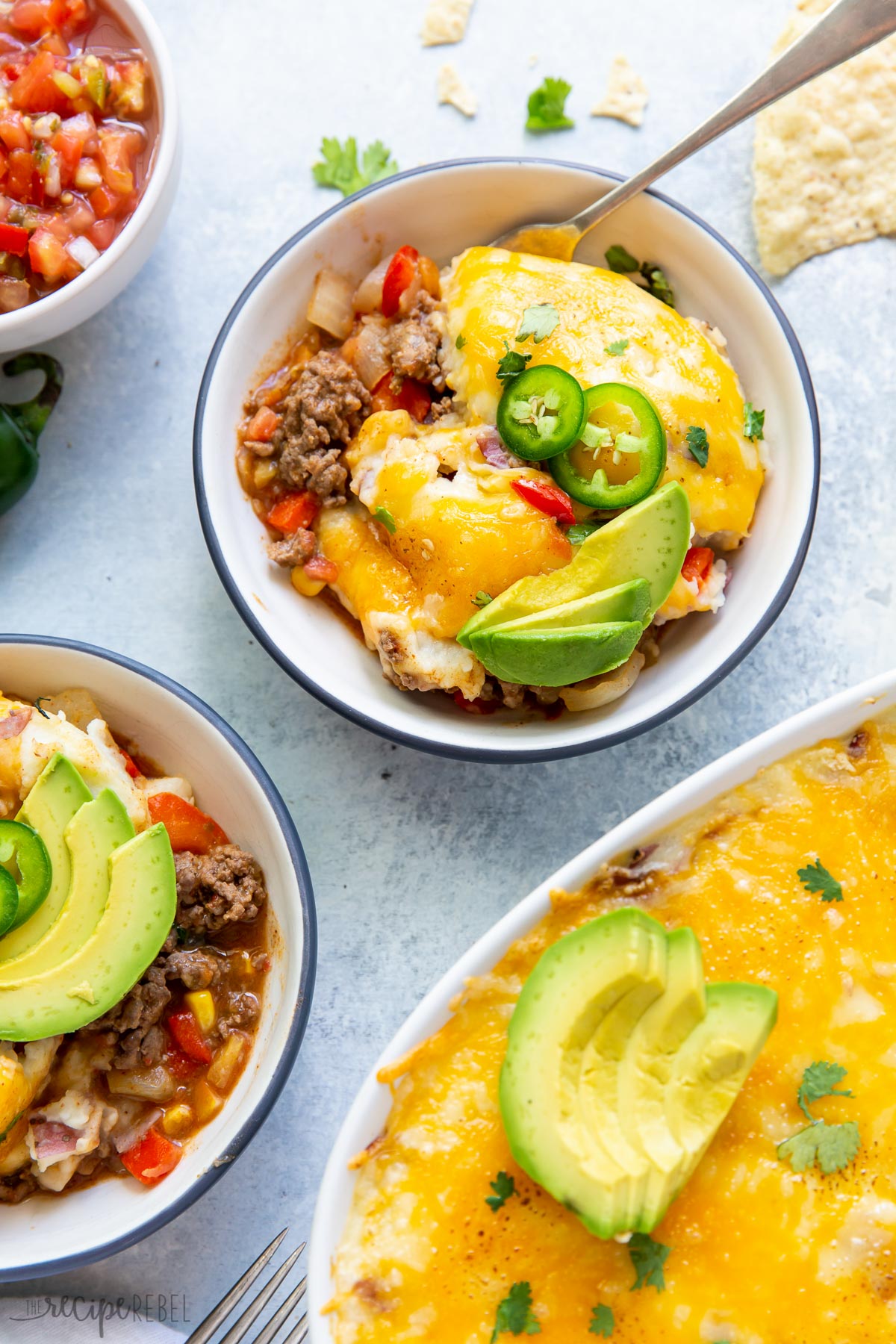 two bowls of mexican shepherds pie with jalapeno and avocado