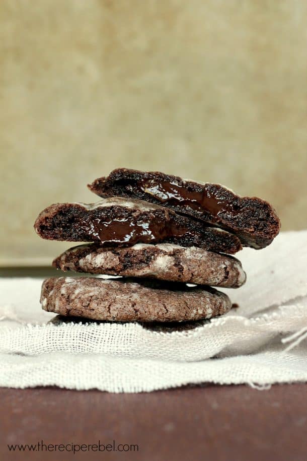 mint chocolate truffle cookies stacked with top cookie broken in half to reveal filling