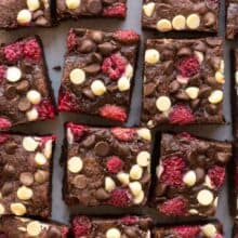 triple chocolate raspberry brownies close up cut in squares