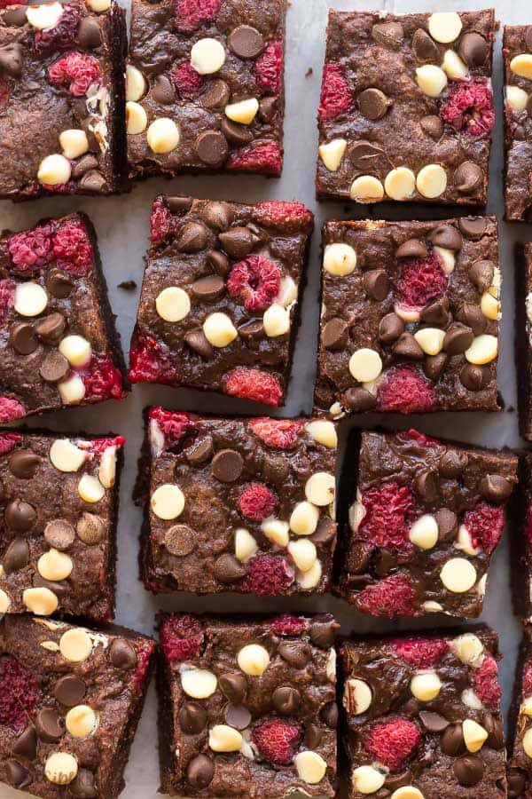triple chocolate raspberry brownies close up cut in squares