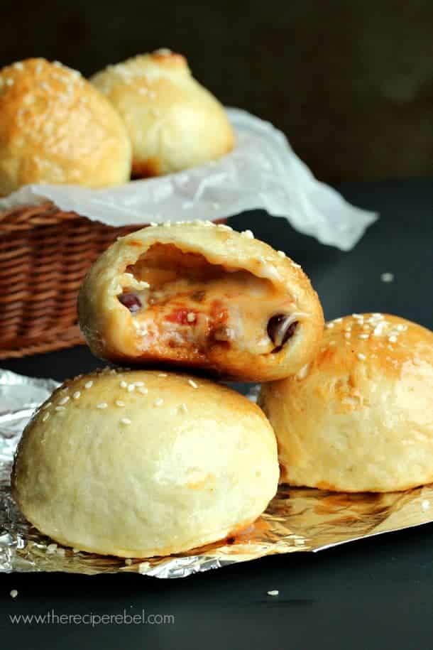chili cheese pretzel bites stacked on piece of foil with bite taken out of top pretzel