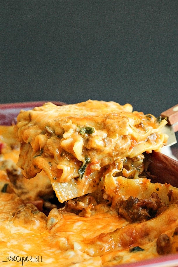 piece of chipotle italian sausage lasagna being scooped out of pan