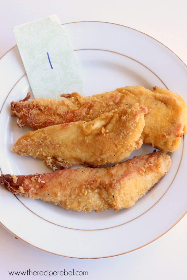 three pieces of oven fried chicken on white plate with a number 1 note on plate