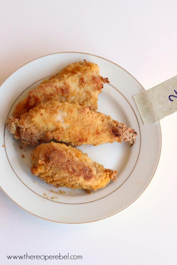 three pieces of oven fried chicken on white plate with a number two note on it