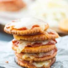 Pizza Crackers: The easiest 4-ingredient snack, appetizer or lunch for the kids! Easily change them to your tastes. Less than 10 minutes start to finish! www.thereciperebel.com