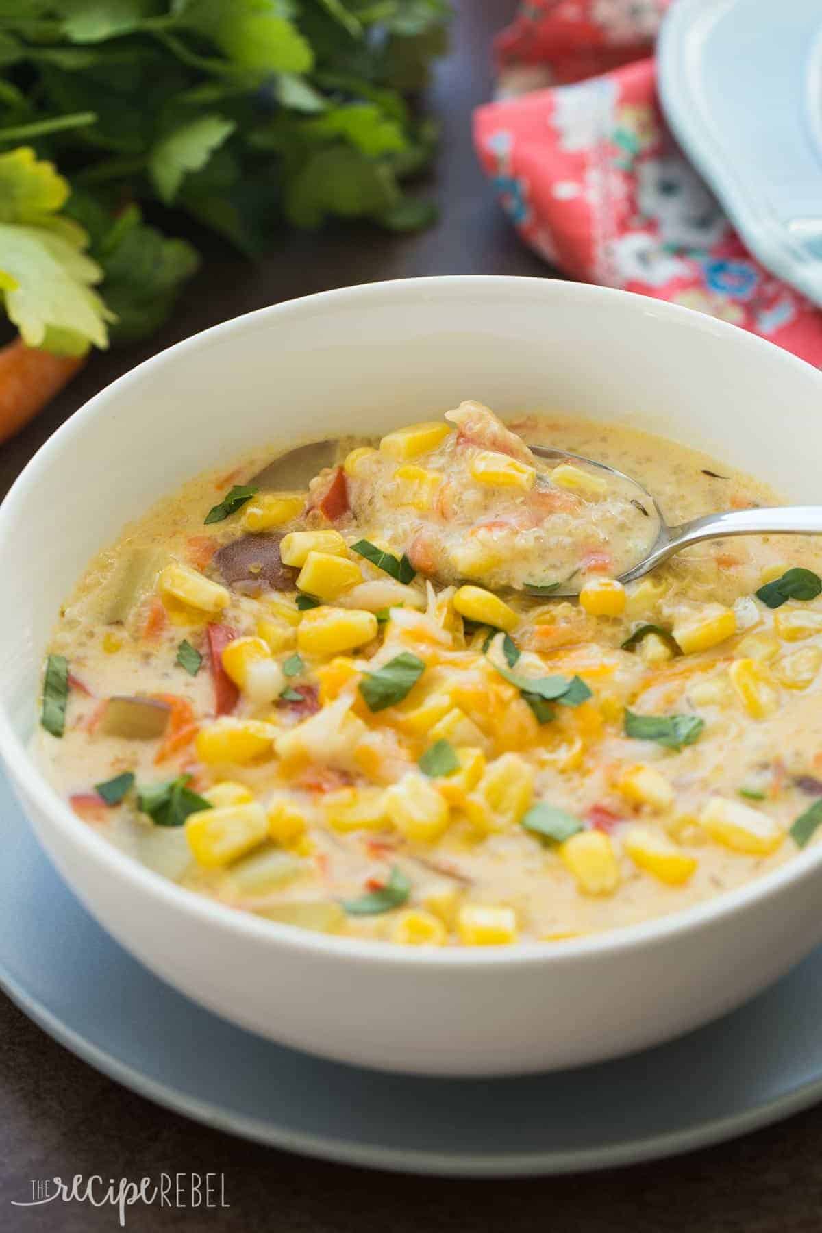quinoa corn chowder in white bowl with spoon scooping soup