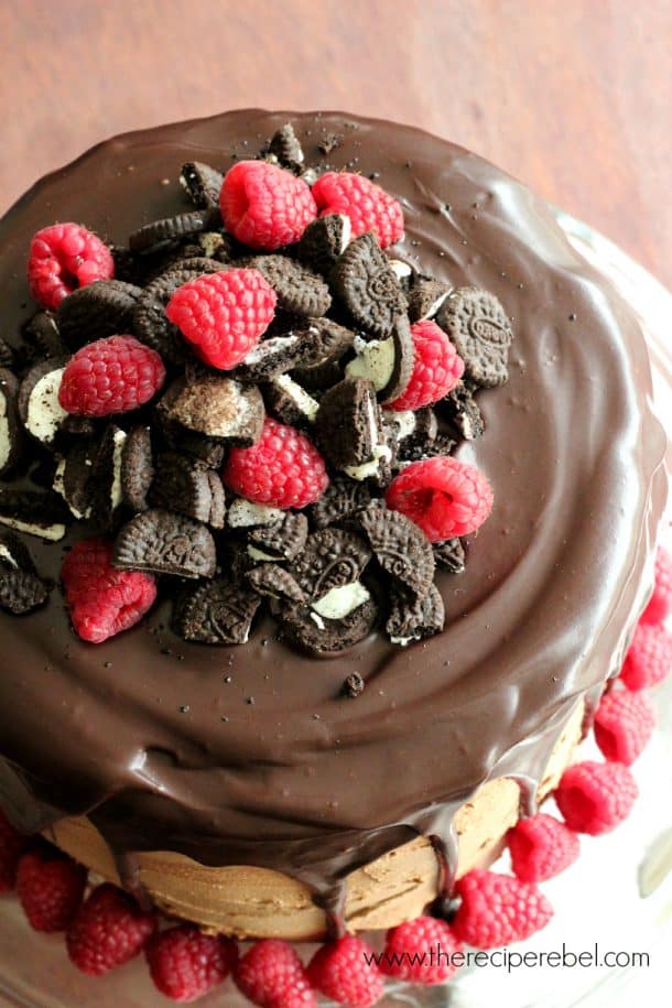 overhead image of raspberry oreo mocha cheesecake cake with fresh raspberries and crushed oreos