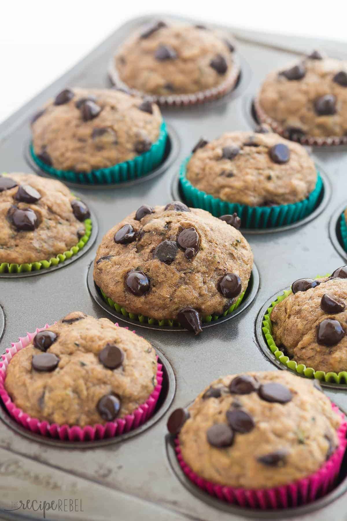 muffin pan with banana chocolate chip zucchini muffins in colorful liners