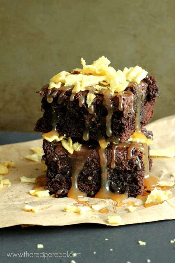 stack of two brownies topped with caramel sauce and crushed potato chips