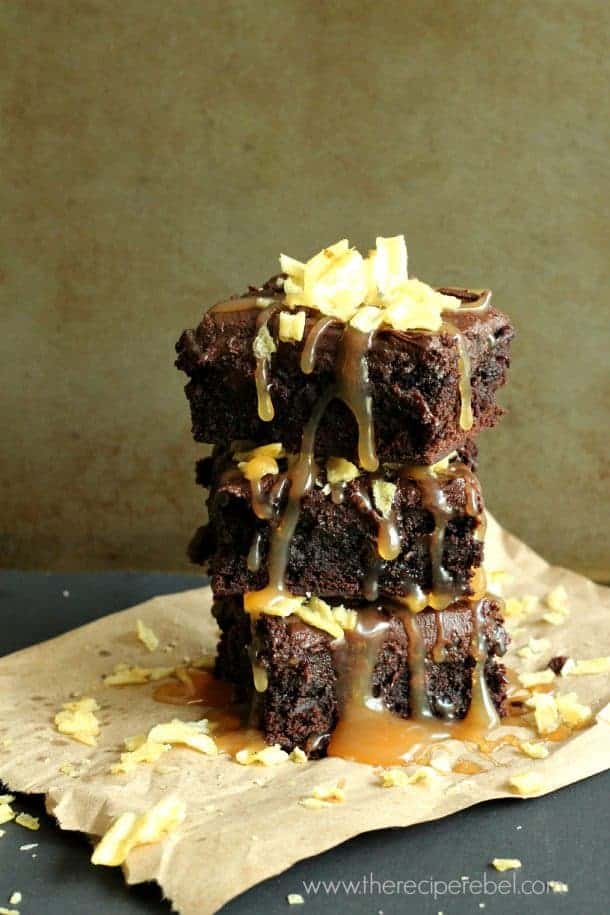 stack of three caramel potato chip brownies on parchment paper